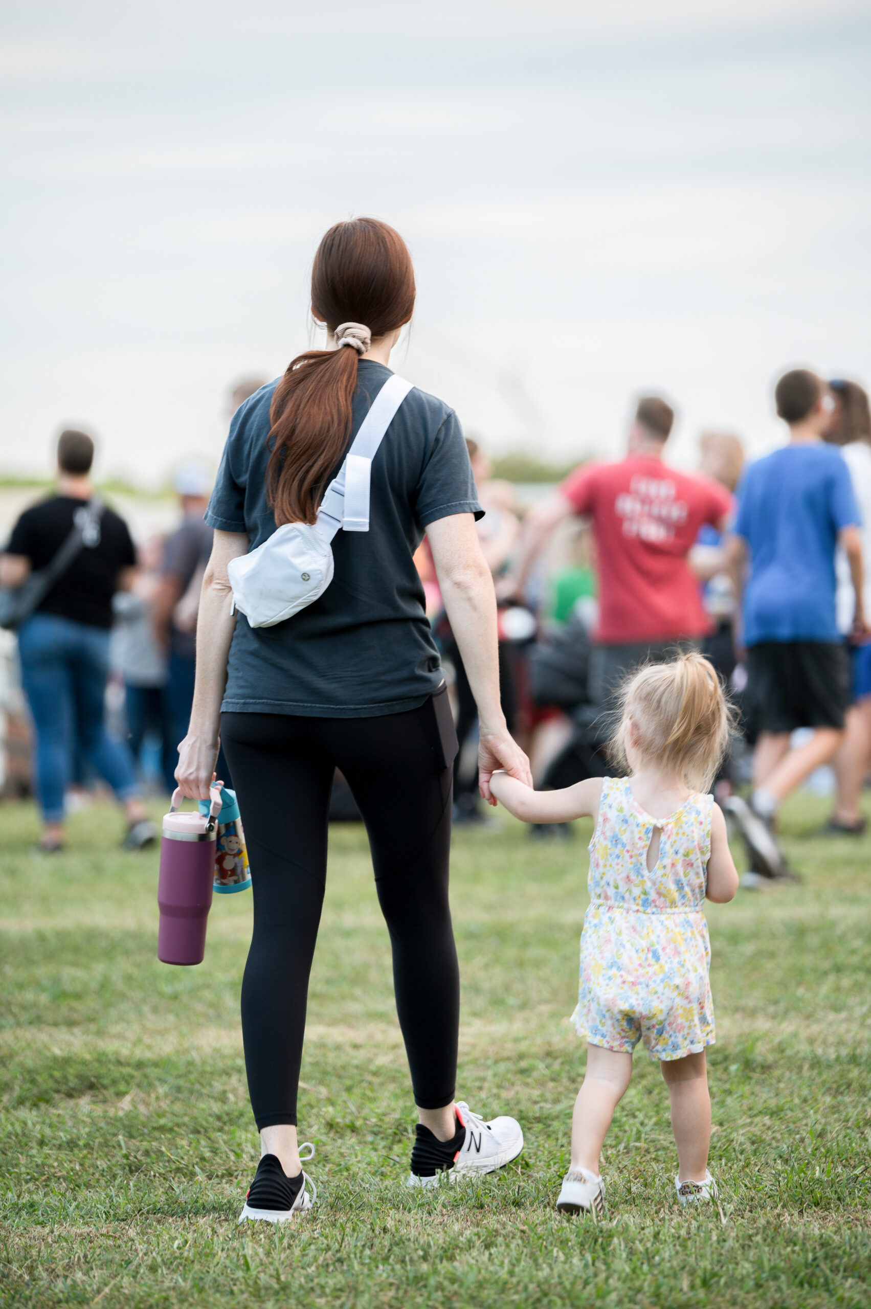 Mother and child holding hands.