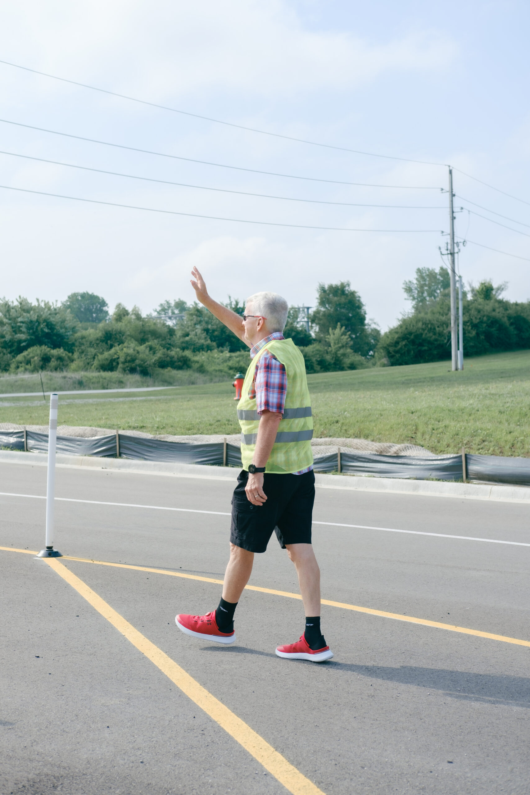 Member of the Vineyard First Impressions group greeting attendees as they enter the parking lot.