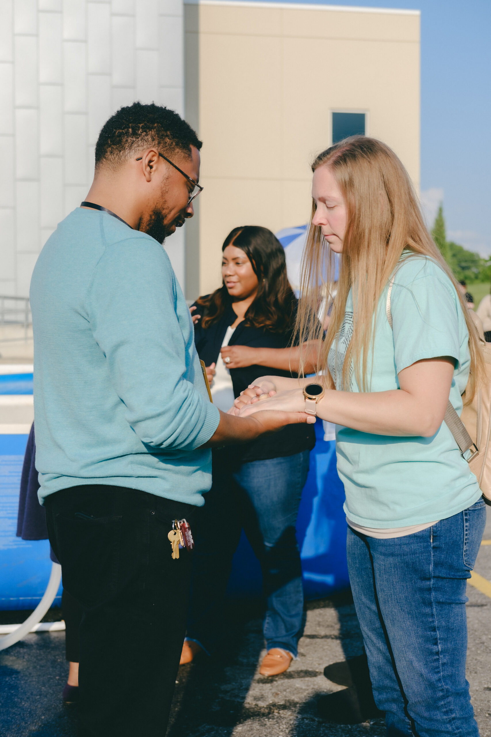 Individuals praying together.