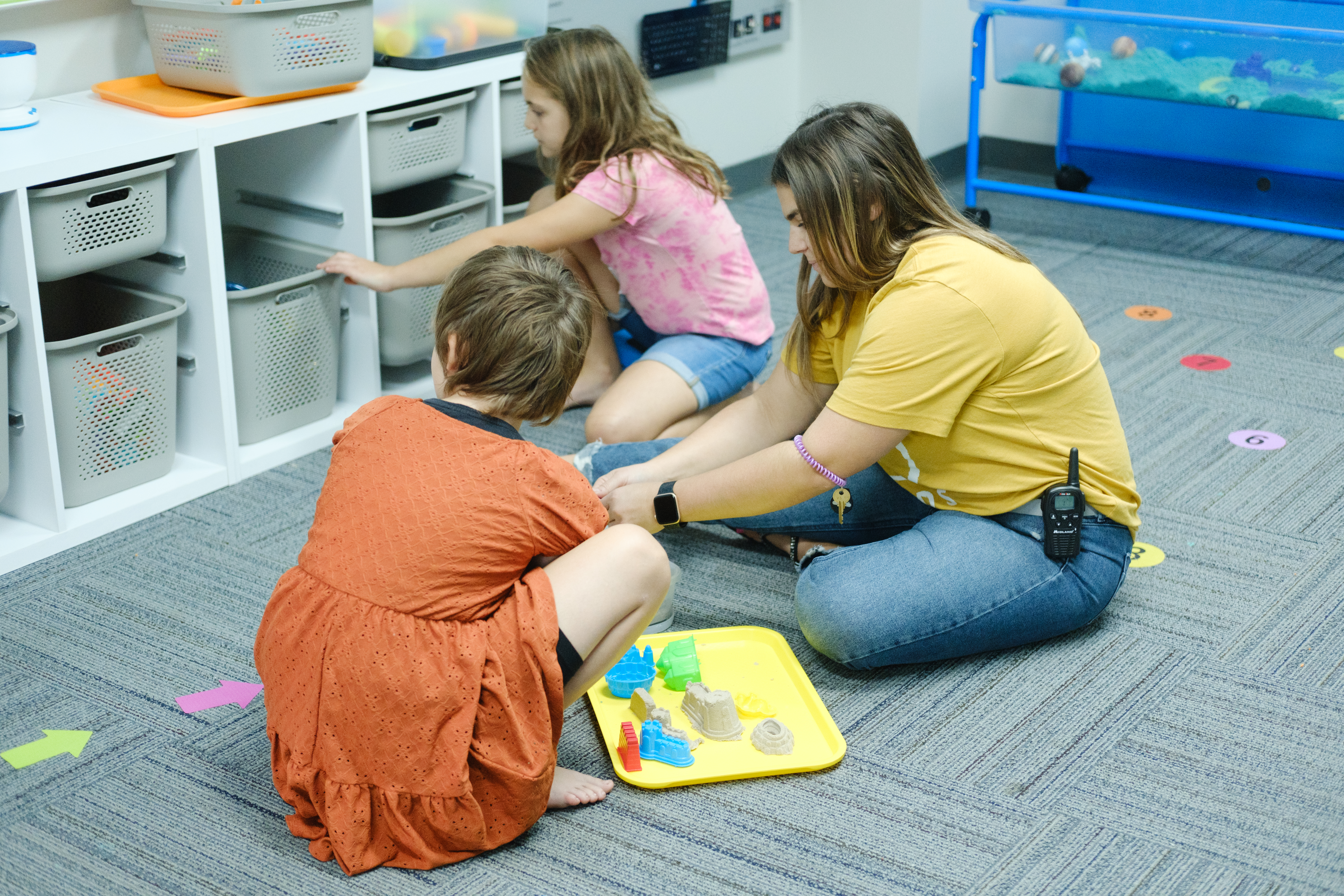Volunteer interacting with kids in the special needs sensory room.