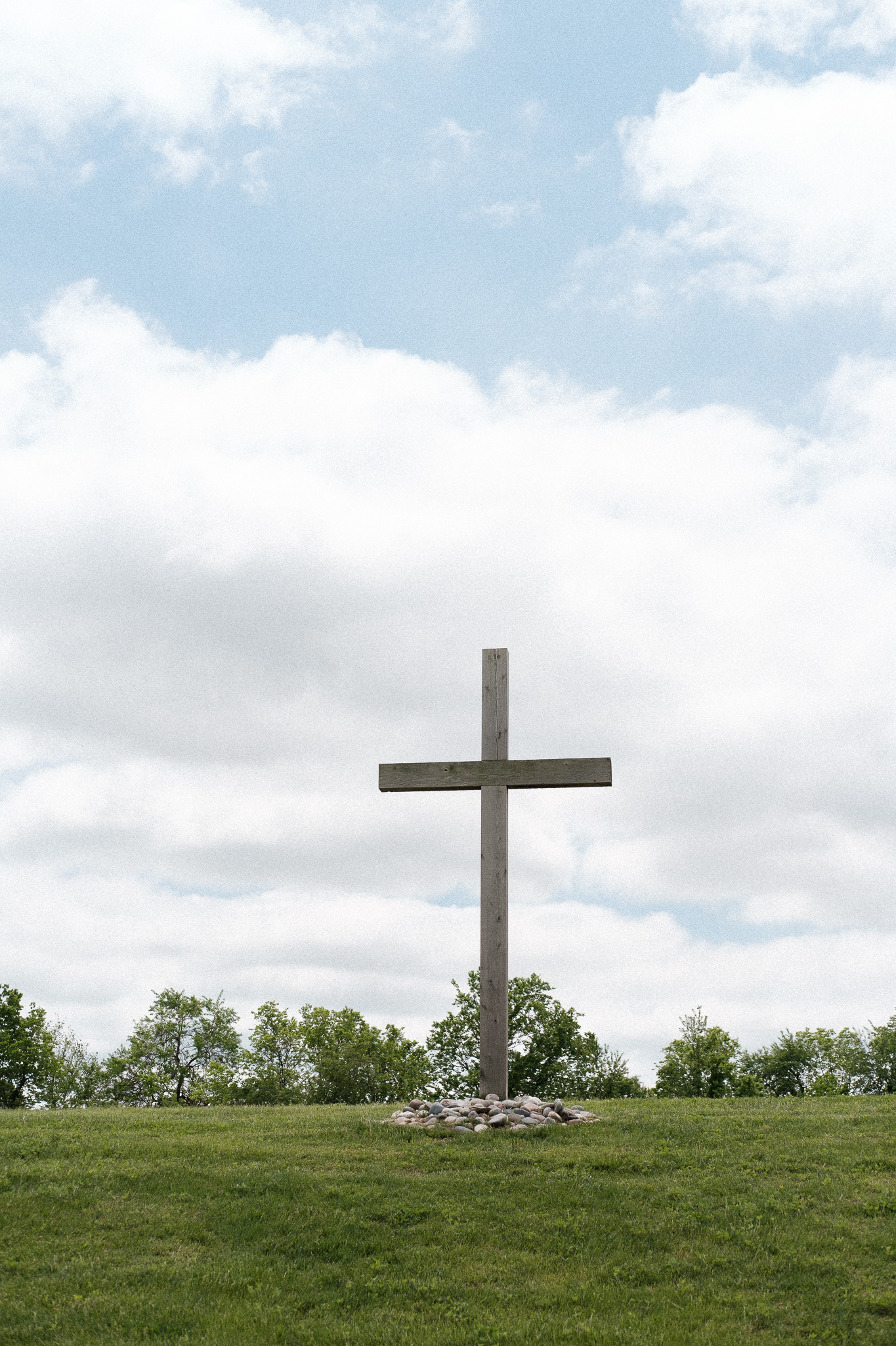 A wooden cross on a hill.